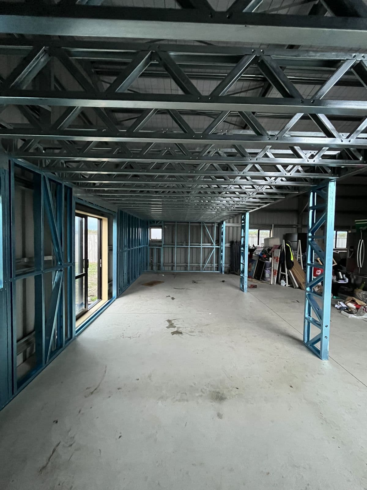 Light gauge steel mezzanine floor framing on steel posts inside an industrial building