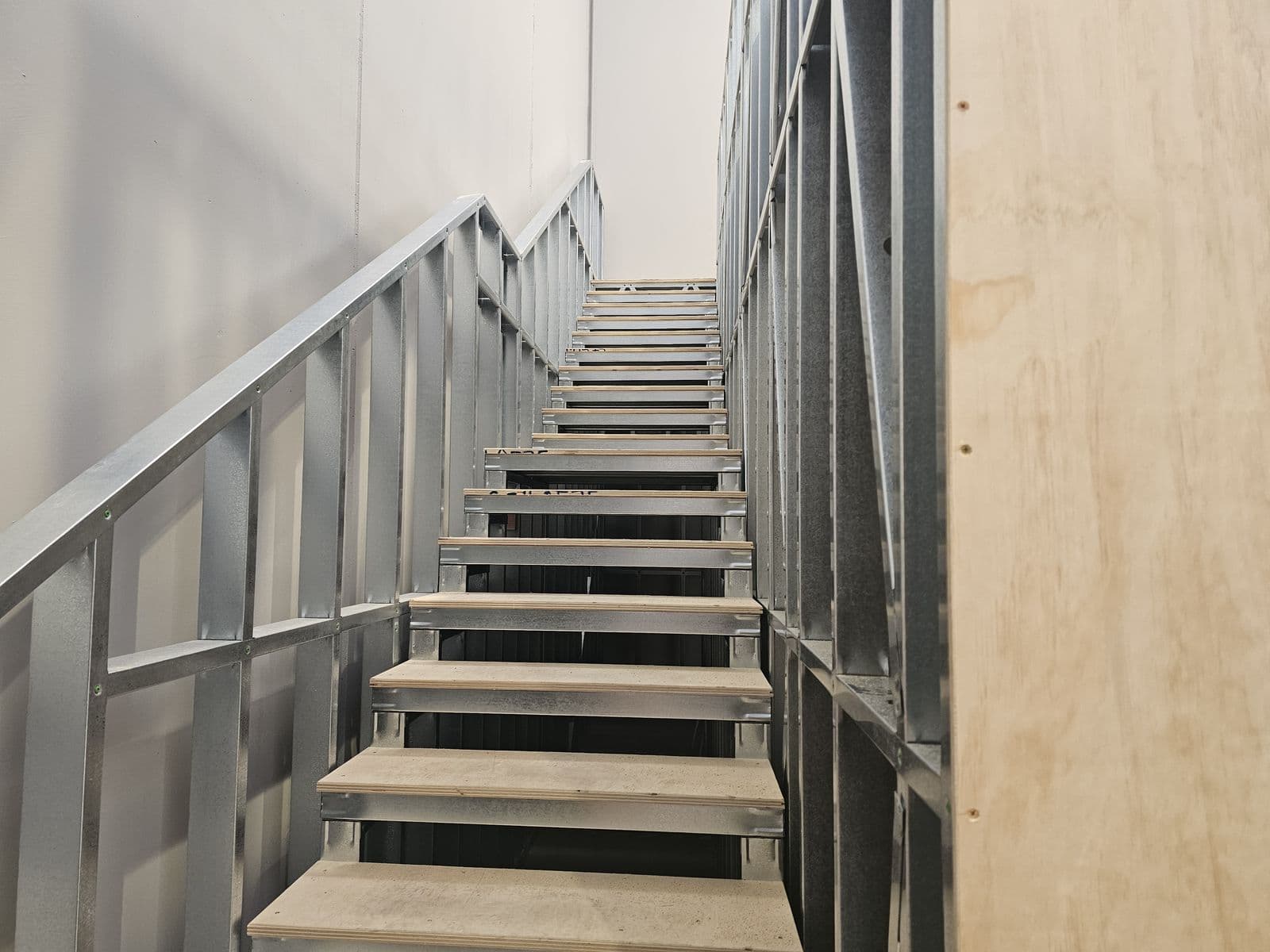 Stairs and handrail up to a light gauge steel mezzanine floor